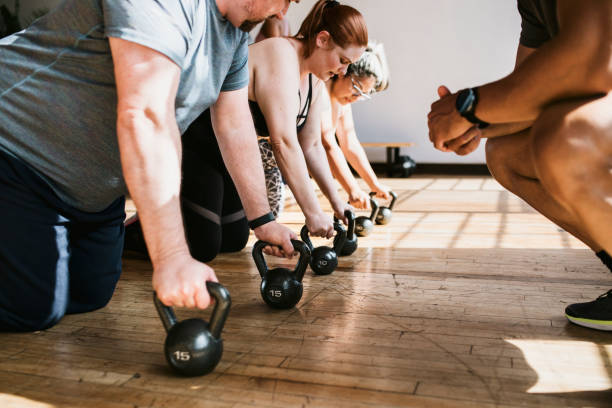 istock Coach training his students to lift a kettlebell 2157637531