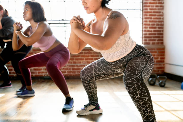 istock Women doing squats in fitness class 2157637580