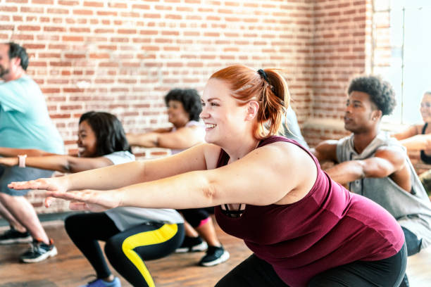 People doing squats in fitness class