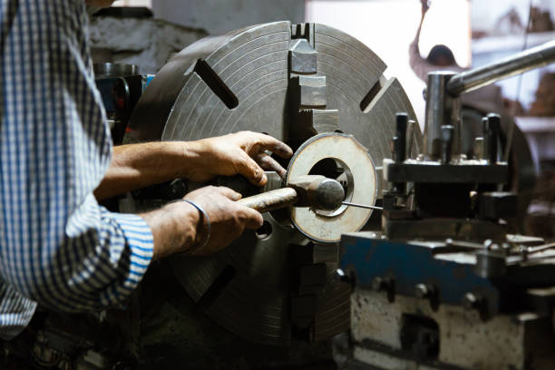 istock Old Man Operating Vintage Lathe Machine in Original Factory. 2157645743