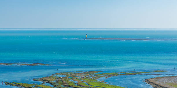 Phare d'Antioche lighthouse and Atlantic ocean seen from the Pointe de Chassiron in France