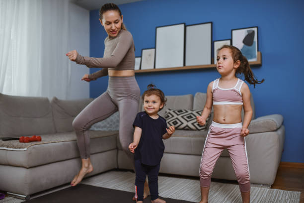 istock Happy Single Mother Doing Home Workout With Female Children 2157648689