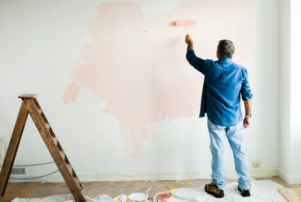 istock Man painting the walls pink 2157651197