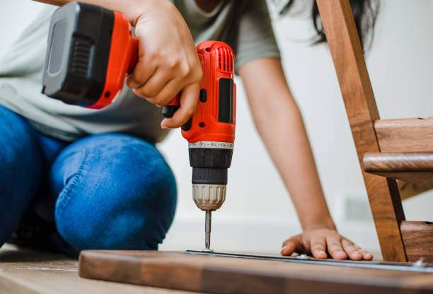 istock Woman using hand drill to assemble a wooden table 2157651298