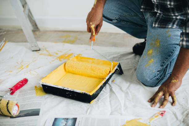istock Man painting the walls yellow 2157651535