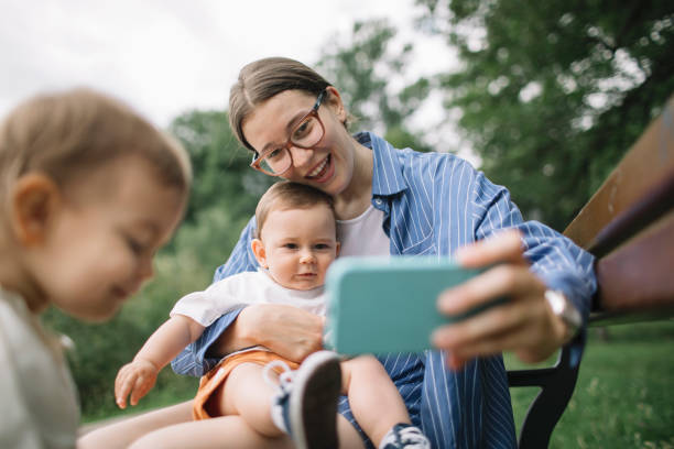 istock Mom and kids phone play 2157652239