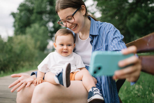 istock Mom and baby phone play 2157652242