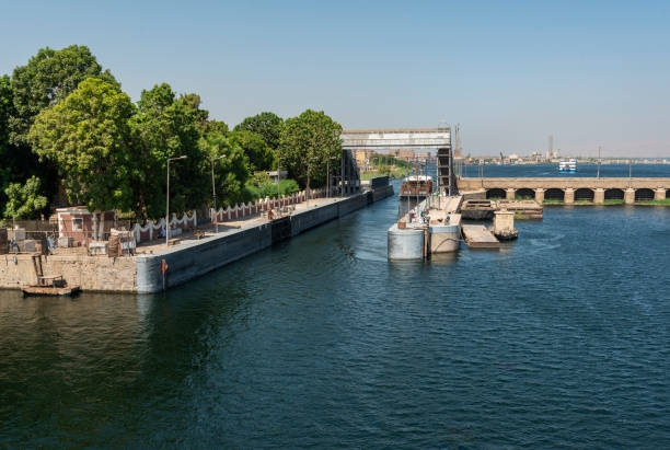 Cruise ships exits the sluice gate on the Nile river barrage bridge at Esna in Nile river. Egypt, North Africa.