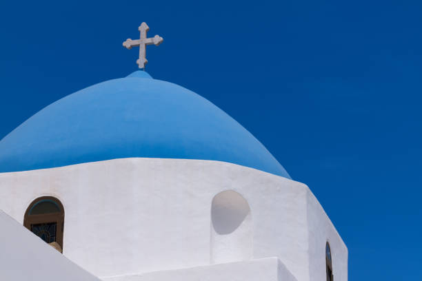 View of the top of a beautiful blue and white orthodox Greek church in Ios Greece