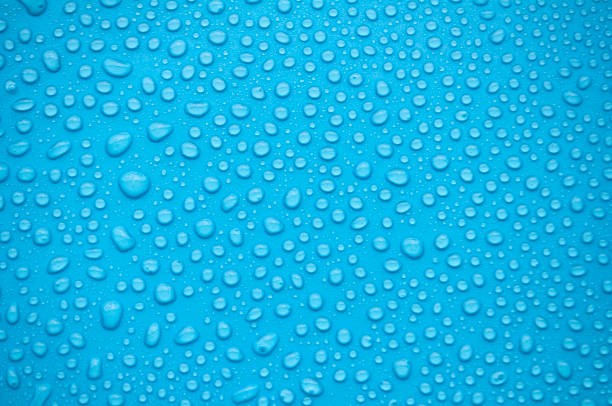 istock Close up of water droplets on blue background 2157654874