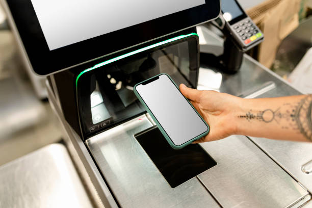 istock Blank phone screen image, held by a woman doing contactless payment 2157655502