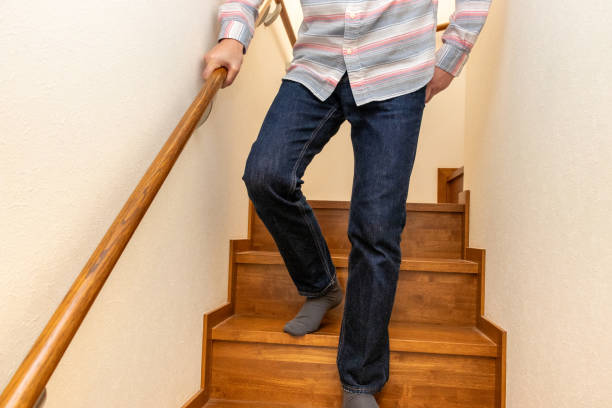 istock A man descending the stairs while holding the handrail 2157655926