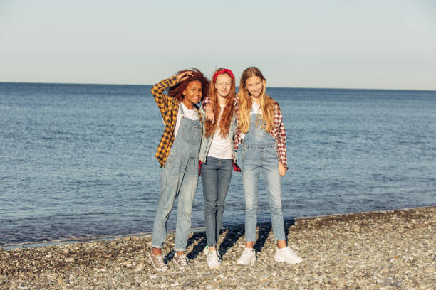 istock Three young girls relaxing on the beach 2157656172