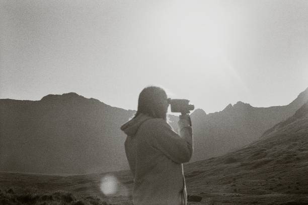 istock Retro video camera, traveler in Scottish nature 2157657039