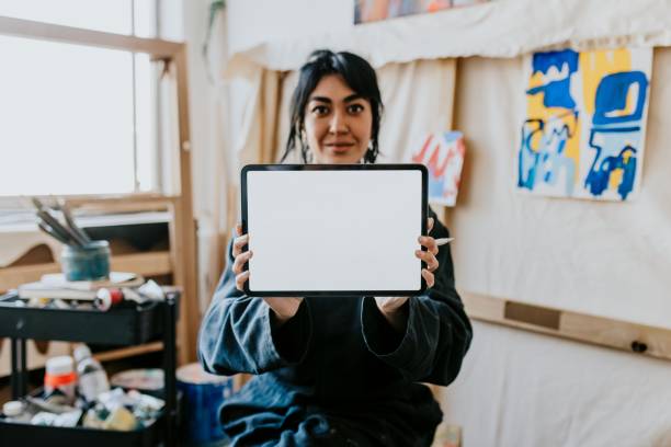istock Woman artist showing blank digital tablet screen 2157657561