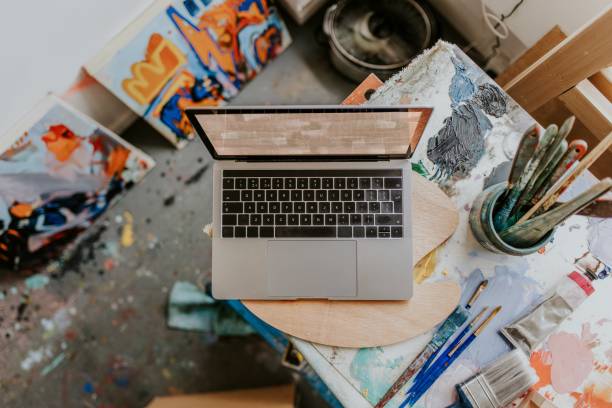 istock Laptop on a table in an artist studio 2157657720