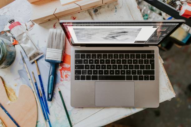istock Laptop on a table in an artist studio 2157657726