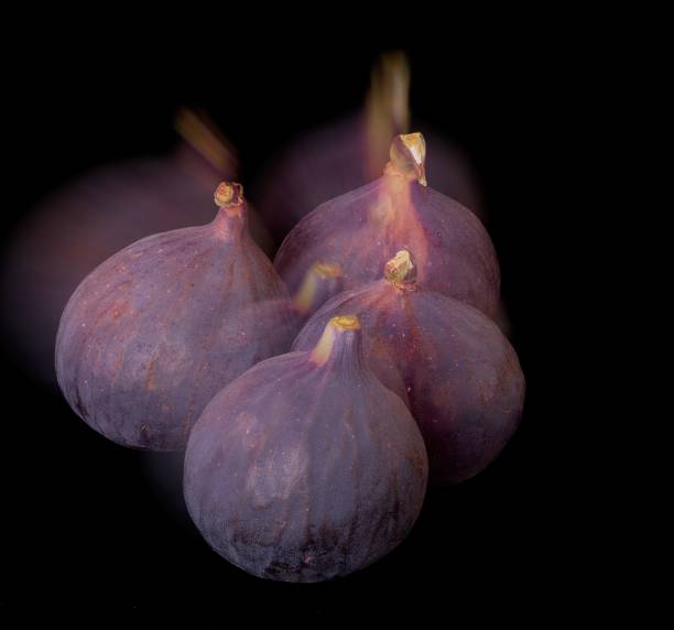 Fig fruits lie on a black background