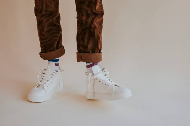 istock Model wearing white sneakers with untied shoelaces 2157659324