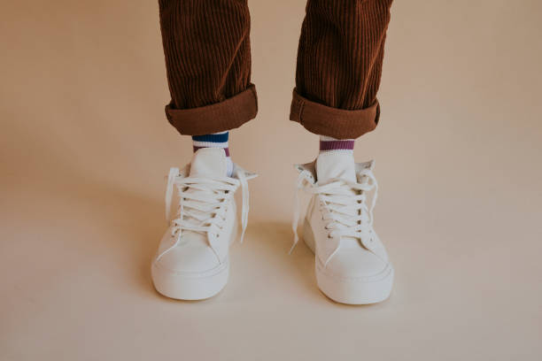 istock Model wearing white sneakers with untied shoelaces 2157659325