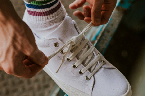 istock Man tying shoelaces on canvas sneaker 2157659350