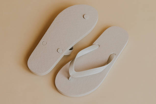 istock Off white flip flop slipper on beige 2157659371