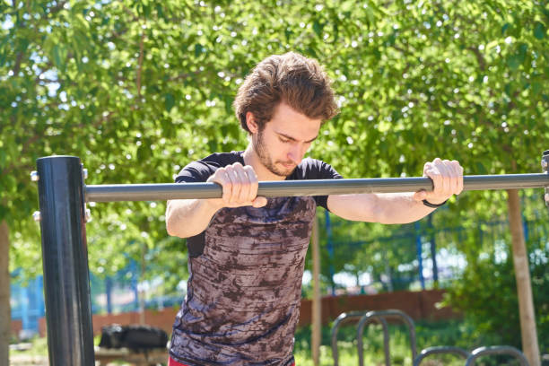 istock young caucasian athlete stretching in a calisthenics park 2157660406