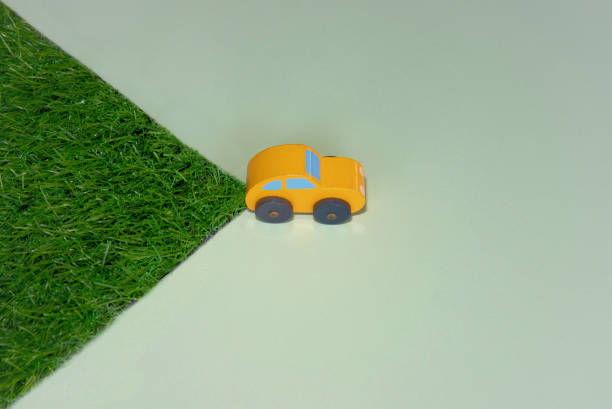 Conceptual image of car and green grass. Environmentally friendly car, eco-friendly transport concept.