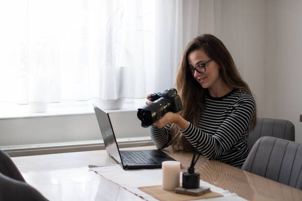 istock Female photographer checking her images on her camera, preparing for edit. 2157661171