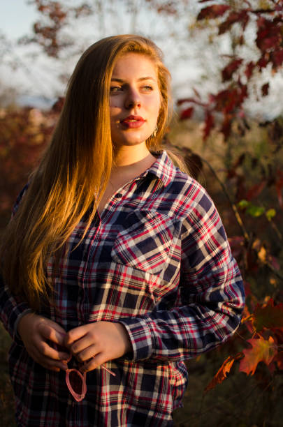 A young girl walks outdoors in the autumn forest