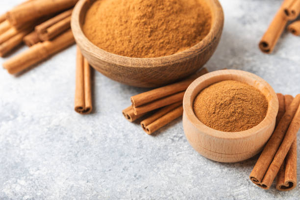 istock Ceylon cinnamon.Cinnamon sticks on a textured wooden background. Cinnamon roll and powder. Spicy spice for baking, desserts and drinks. Fragrant ground cinnamon. Close-up. Place for text. copy space 2157663054
