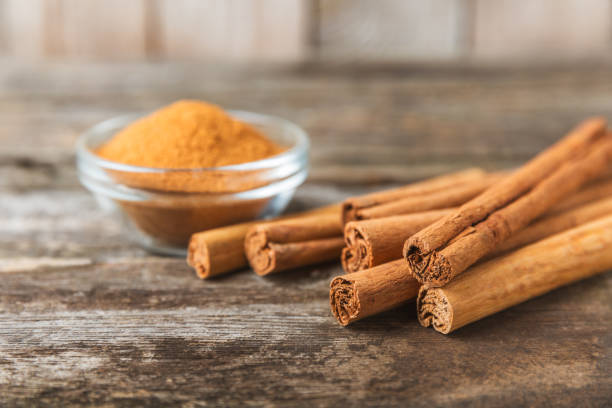 istock Ceylon cinnamon.Cinnamon sticks on a textured wooden background. Cinnamon roll and powder. Spicy spice for baking, desserts and drinks. Fragrant ground cinnamon. Close-up. Place for text. copy space 2157663322