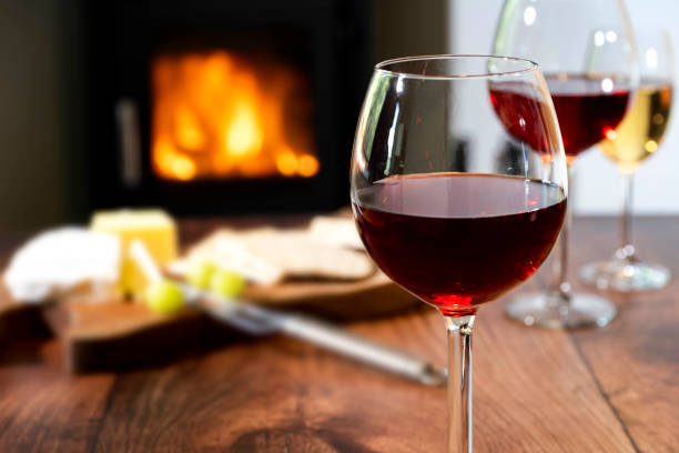 istock Red Wine and cheese board by the fireside - Stock photo 2157663559