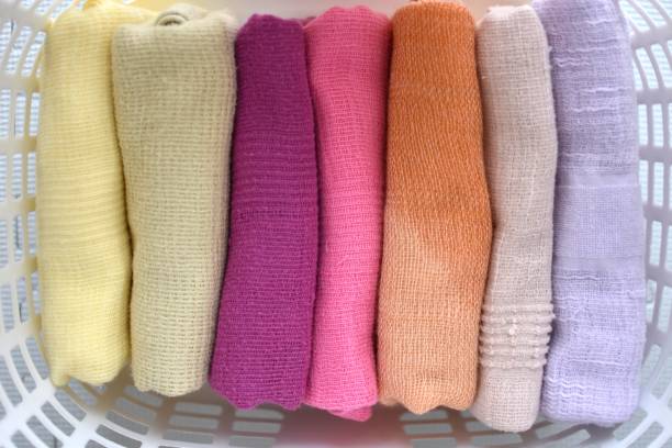 Colorful, handmade wool socks and knitted winter hats showcasing traditional craftsmanship on a wooden shelf in a cozy setting