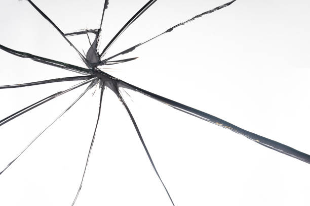 Broken glass close-up. Problem metaphor. White background with crack. Background on theme of breakage. Pattern with shattered mirror. Shattered background. Broken glass texture