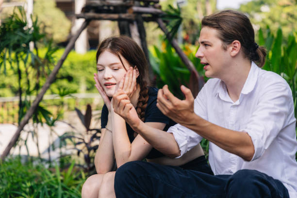 istock Young Caucasian Couple Having a Serious Conversation Outdoors 2157667678