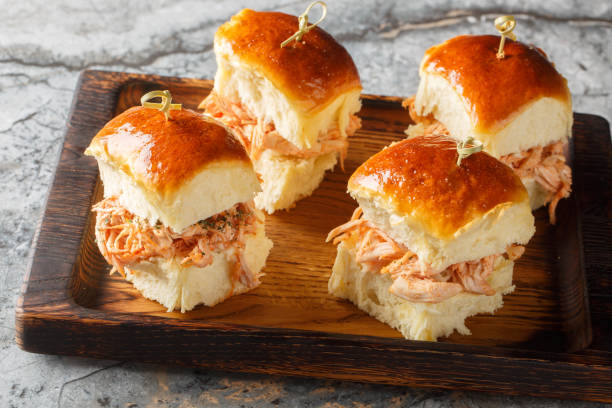 istock Chicken Cheese Sliders roll made with pulled chicken, tomato sauce, and Mozzarella closeup on the wooden board. Horizontal 2157667883
