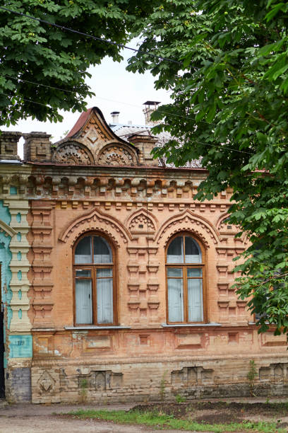 istock Wall of yellow building with arched windows on summer day 2157671510