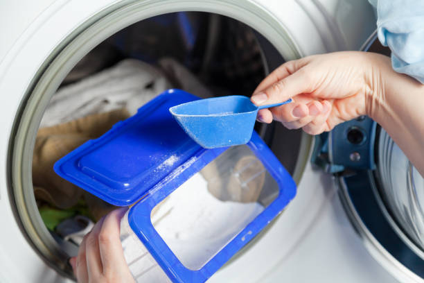 istock Woman hands picking up washing powder from a box 2157671911
