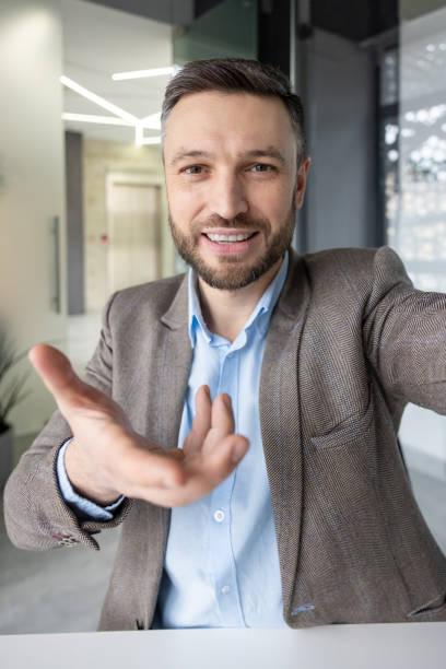 istock Businessman reaching out during an online video call in a modern office environment 2157674061