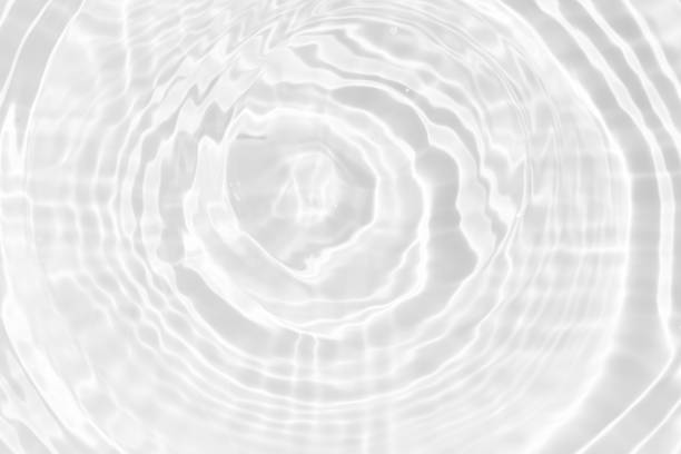 istock White water with ripples on the surface. Defocus blurred transparent white colored clear calm water surface texture with splashes and bubbles. Water waves with shining pattern texture background. 2157680212