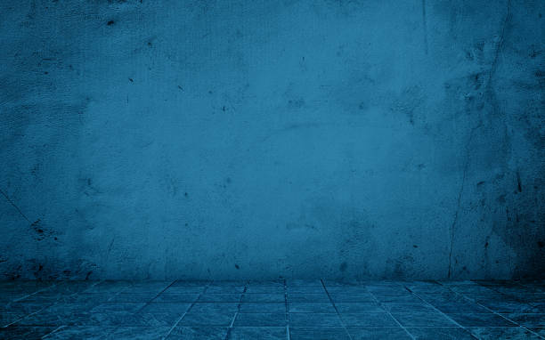 istock blue concrete perspective room for advertising. stamp concrete floor in grid pattern with weathered navy concrete wall background. blue backdrop space for displayed product. 2157689162