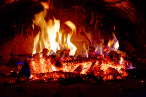 istock Bright flames rise energetically from burning wood logs. 2157691340