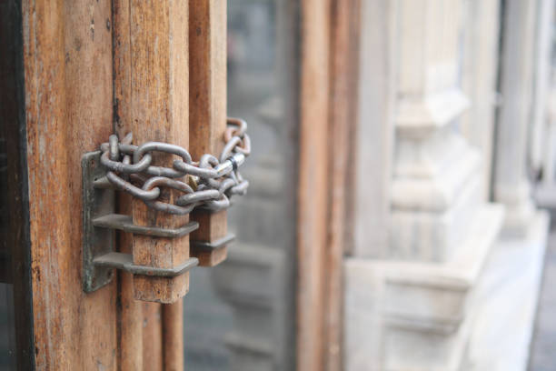 Closed old rusty lock on a wooden door.
