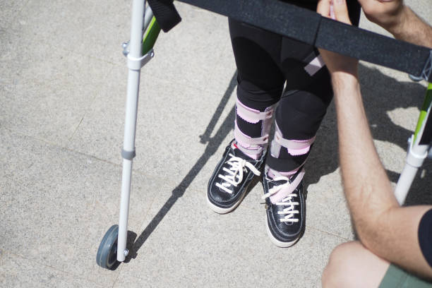 istock child with walking frame and knee orthosis outdoor 2157694227