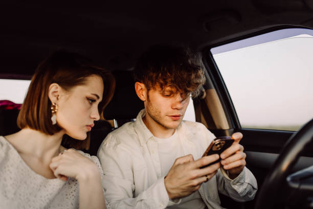 istock young couple in a car on a summer trip 2157694300