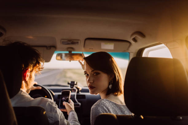 istock young couple in a car on a summer trip 2157694336
