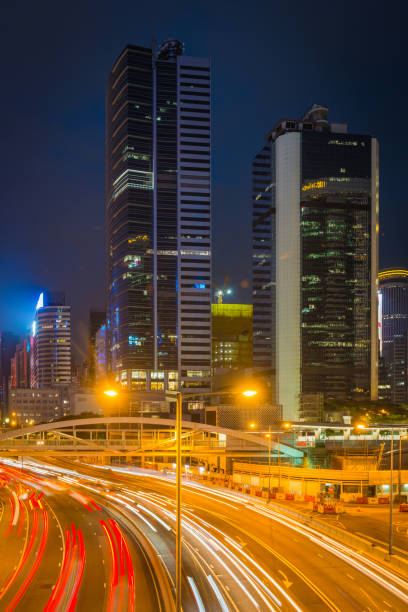 istock Rush hour traffic light trails highway neon night skyscraper cityscape 2157697559