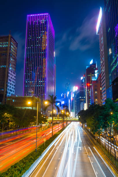istock Light trails rush hour traffic through neon night Hong Kong 2157697571