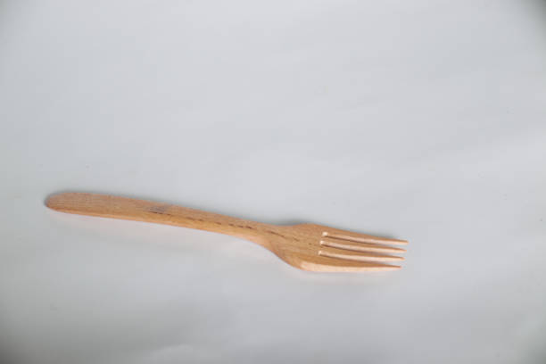 Wooden fork on white background. Tool for eating food
